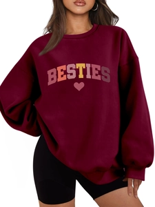 Detail of burgundy oversized sweatshirt featuring BESTIES text and heart graphic