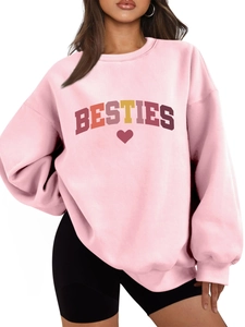 Detail of pink oversized Besties sweatshirt showing colorful lettering and heart print