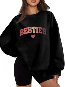 Close-up of BESTIES letter print and red heart on black long sleeve sweatshirt