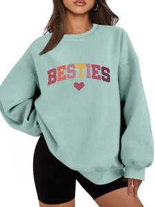 Detail of mint green sweatshirt featuring BESTIES text and red heart graphic