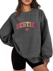 Close-up of BESTIES colorful lettering and red heart print on dark grey sweatshirt