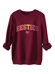 Macro detail of wine red sweatshirt featuring BESTIES rainbow print and ribbed cuffs