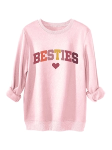 Close-up of pink crewneck sweatshirt with BESTIES text and heart print detail