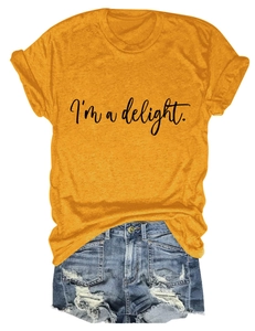Flat lay of yellow T-shirt with 'I'm a delight' slogan and distressed blue denim shorts