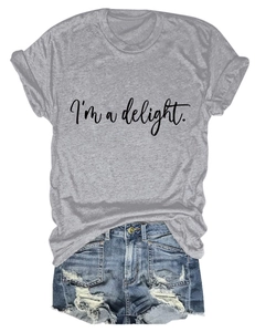 Flat lay of gray cotton T-shirt with I'm a delight print and ripped denim shorts