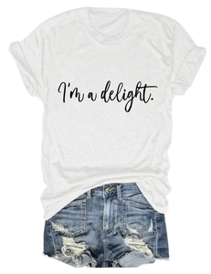 Flat lay of a white crew neck T-shirt with I'm a delight text and ripped denim shorts
