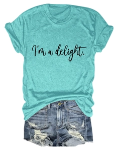 Detail of turquoise cotton T-shirt with I'm a delight print and ripped denim shorts