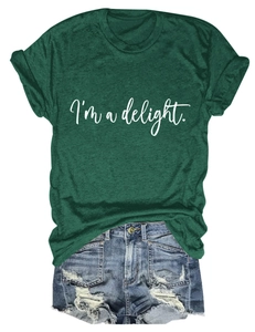Flat lay of a dark green crew neck T-shirt with I'm a delight text and denim shorts