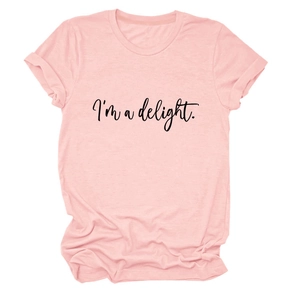 Detailed close-up of cursive 'I'm a delight' print on a pale pink cotton t-shirt