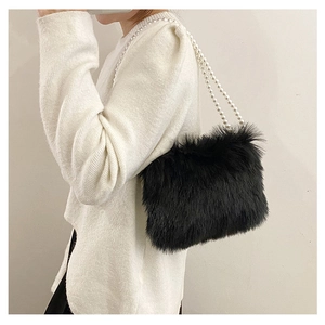 Détail du sac à bandoulière en peluche noire avec bandoulière perlée élégante et fausse fourrure