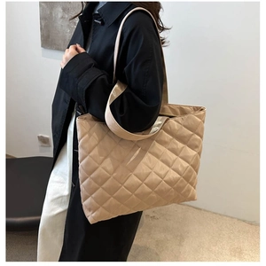 Quilted tote bag in champagne satin with large capacity, shown on model's shoulder