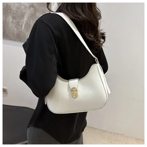 Detail of white crescent underarm bag showing smooth faux leather and gold metal clasp