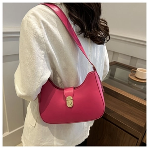 Detailed view of magenta leather half-moon shoulder bag with golden metallic twist-lock