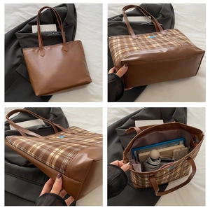 Macro detail of brown leather tote bag showing spacious interior and stitching