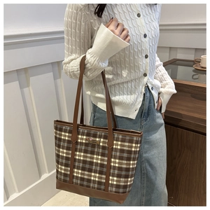 Detail of checkered tote bag with dachshund embroidery and brown leather trim