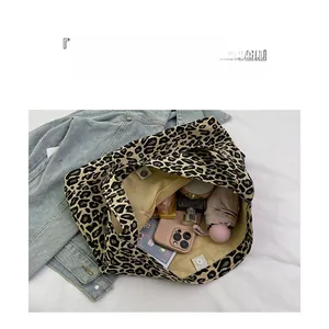 Interior of leopard print canvas tote bag showing large capacity and daily essentials