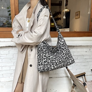 Large capacity leopard print tote bag for women styled with a beige trench coat
