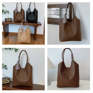 Dettaglio della borsa tote in pelle motivo litchi con foulard in seta