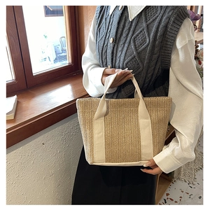 Handmade straw tote bag with cream canvas handles for beach vacations and daily use