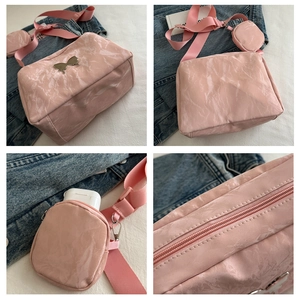 Detailed views of pink marble faux leather shoulder bag with butterfly charm and coin purse