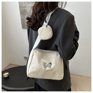 Detail of white pleated faux leather crossbody bag with silver butterfly and small pouch