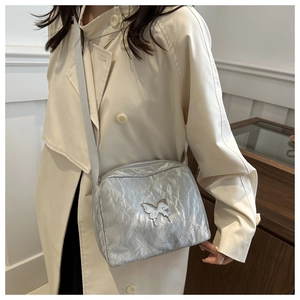 Silver shoulder bag with pleated metallic fabric and butterfly metal ornament