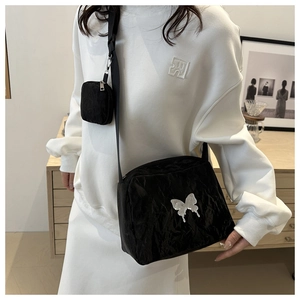Large black textured crossbody bag with silver butterfly and mini pouch on strap