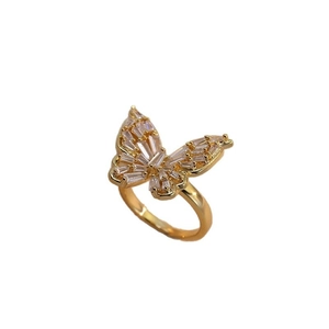 Elegant gold butterfly open ring with cubic zirconia stones on white background