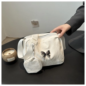 White crinkle texture shoulder bag with silver butterfly emblem and small coin pouch