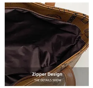 Detail view of the vintage brown letter print tote bag with a secure zipper closure