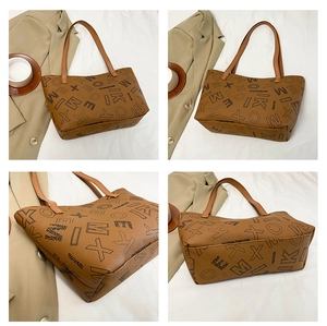 Macro details of brown tote bag with logo pattern, featuring straps and stitching