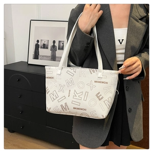 Detail view of white tote bag featuring large leopard print and dotted letter patterns