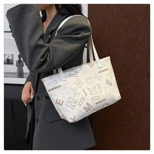 White tote bag with MK MEMOXI monogram print shown on model for daily casual wear