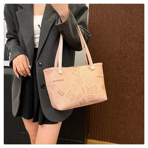Model showing a pink MKMEMOXI tote bag with letter prints for professional commute style
