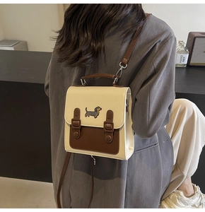 Close-up of a mini backpack featuring a cartoon dachshund embroidery and dual straps