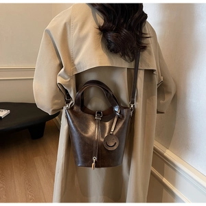 Vintage dark brown leather bucket bag with top handle and shoulder strap for women