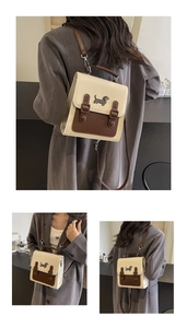Close-up of vintage mini backpack featuring cute dachshund embroidery and brown PU leather strap