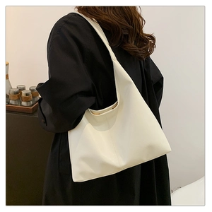 Detailed view of a white PU leather tote bag with vertical stitching for daily commute