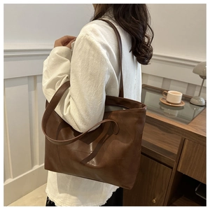 Brown vintage faux leather large tote bag with asymmetric stitching for daily commute