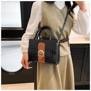 Black faux leather tote bag with brown buckle and crocodile pattern embossing details