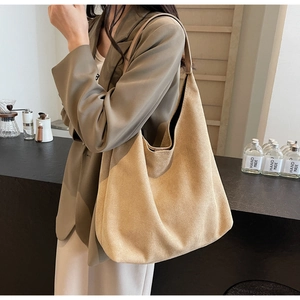 Detail of a large khaki suede hobo tote bag showing its soft texture and slouchy design