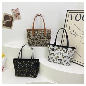 Close-up of stylish jacquard tote bags featuring leopard and butterfly floral patterns