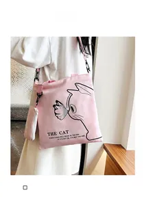 Pink canvas tote bag with cat graphic and matching small coin purse detail
