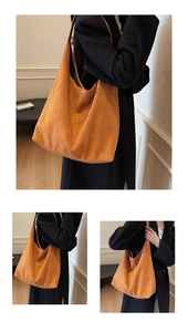Detail shot of a large caramel suede tote bag with wide shoulder straps and hobo silhouette