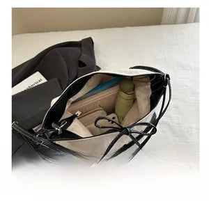 Spacious interior of a contrast tote bag showing storage for daily essentials and a zip closure