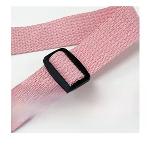 Close-up of pink woven canvas strap with adjustable black plastic buckle detail