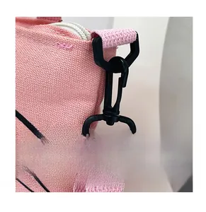 Detail of durable black plastic swivel hook on a pink canvas tote bag shoulder strap