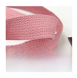 Macro detail of the pink woven shoulder strap featuring clear cotton fiber texture