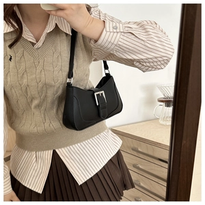 Mirror selfie showing black PU crescent underarm bag with silver buckle and retro style