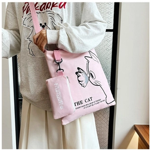 Detail of pink canvas tote bag with cat illustration and matching mini zipper pouch